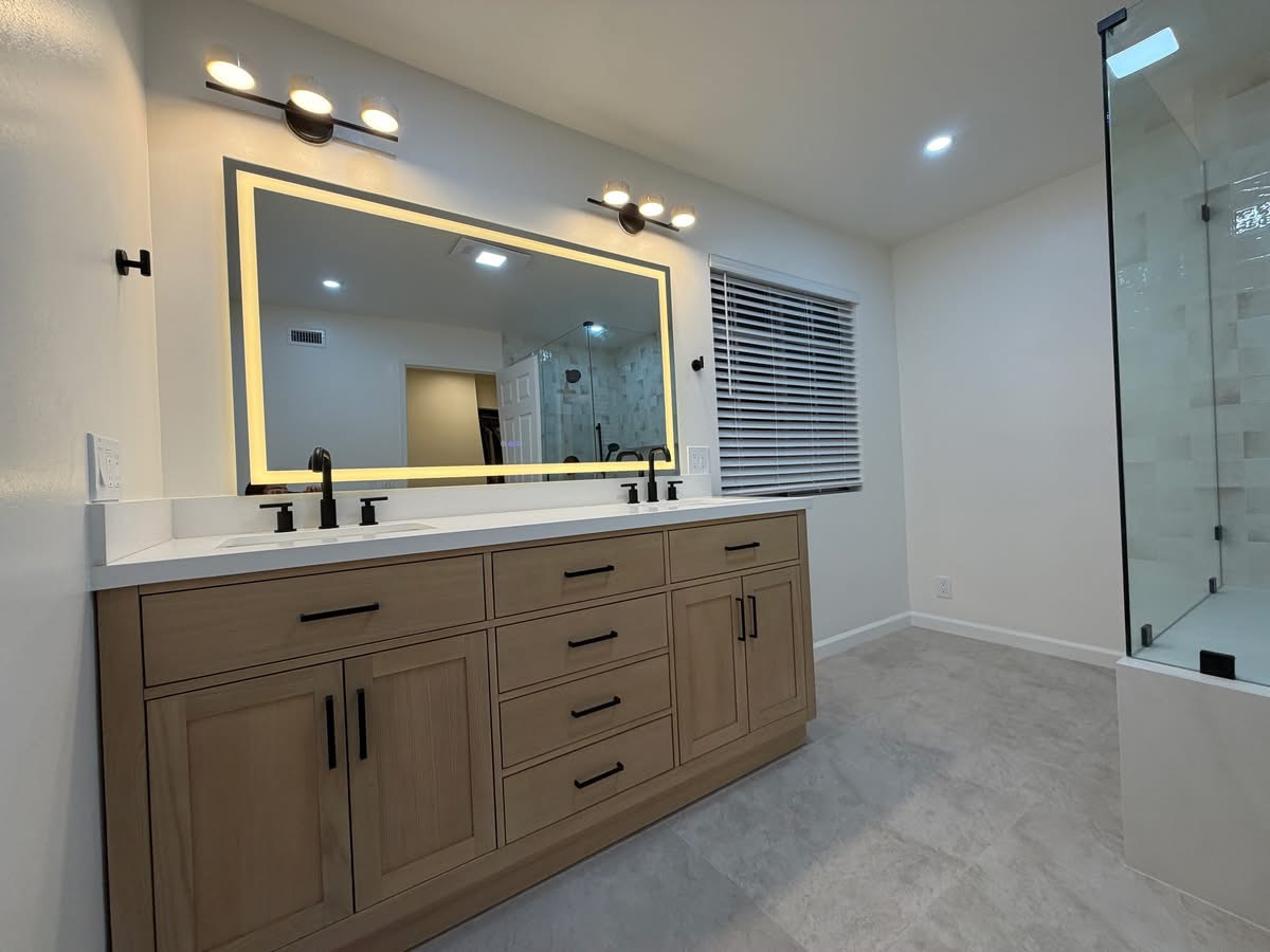 Master bathroom renovation — custom vanity and walk-in shower, completed by Sarasota Building Co.