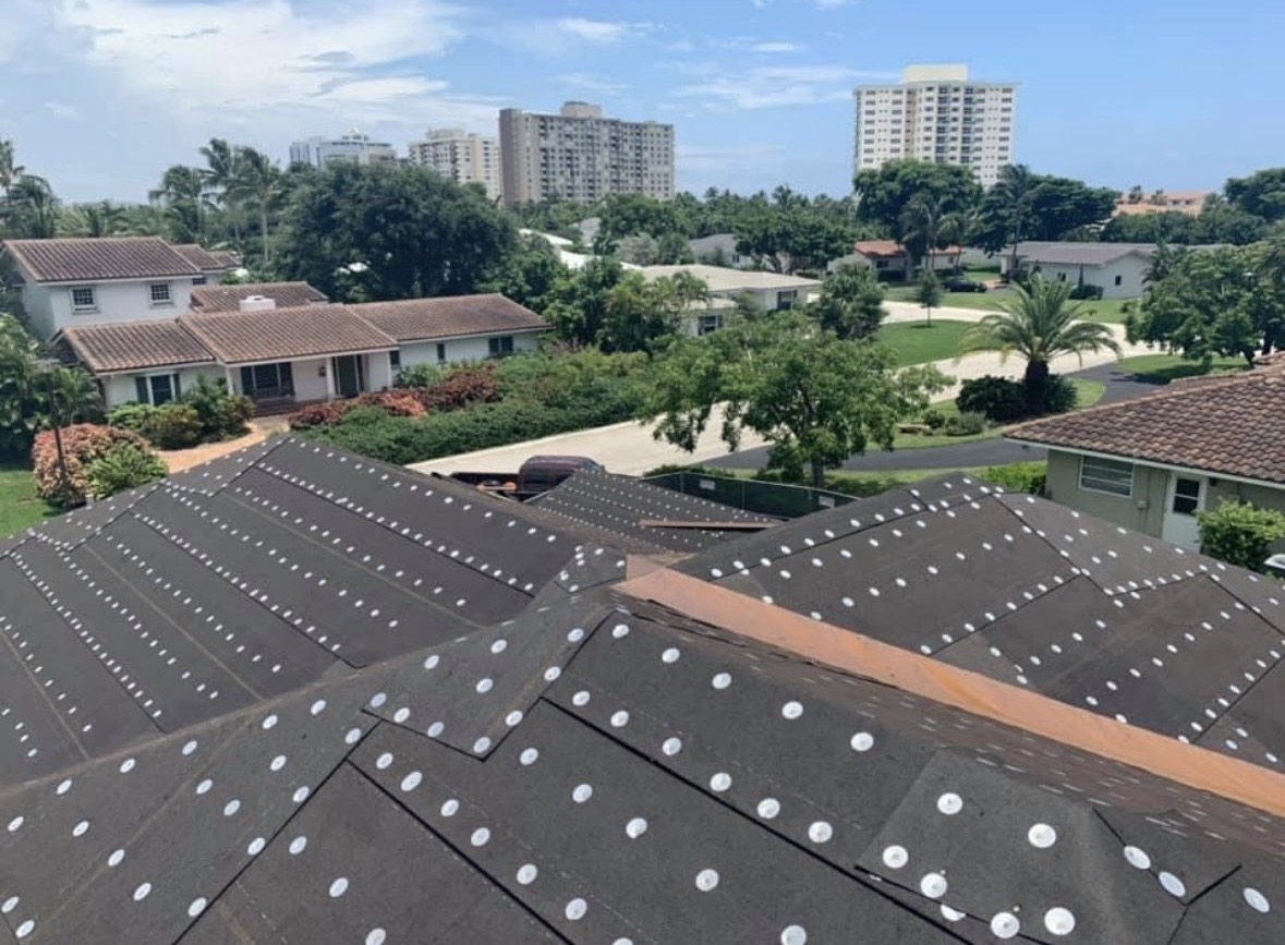 Residential roof installation with underlayment in progress